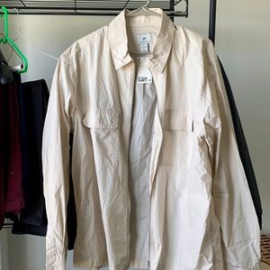 New with tags, cream colored windbreaker size Large